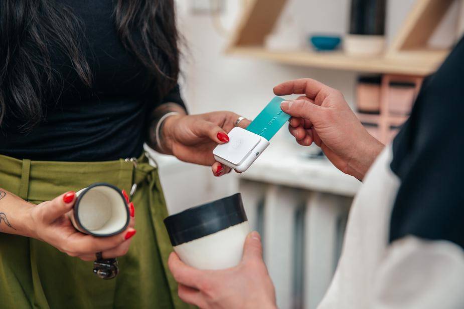Customer using POS card reader for payment on Shopify website build with POS setup. Ideal for eCommerce and retail businesses needing custom solutions.